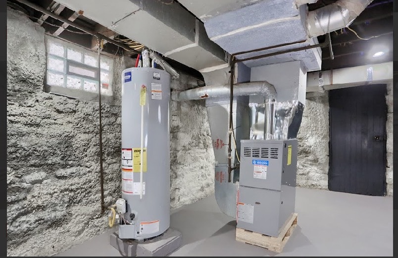 Basement mechanical room with new water heater, furnace, and organized HVAC ductwork installation