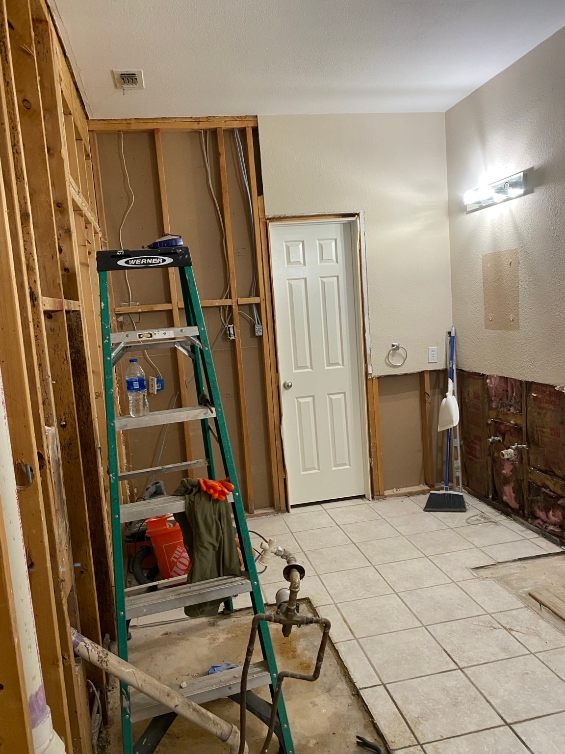 Bathroom renovation in progress showing new framing, rough-in plumbing, and structural work