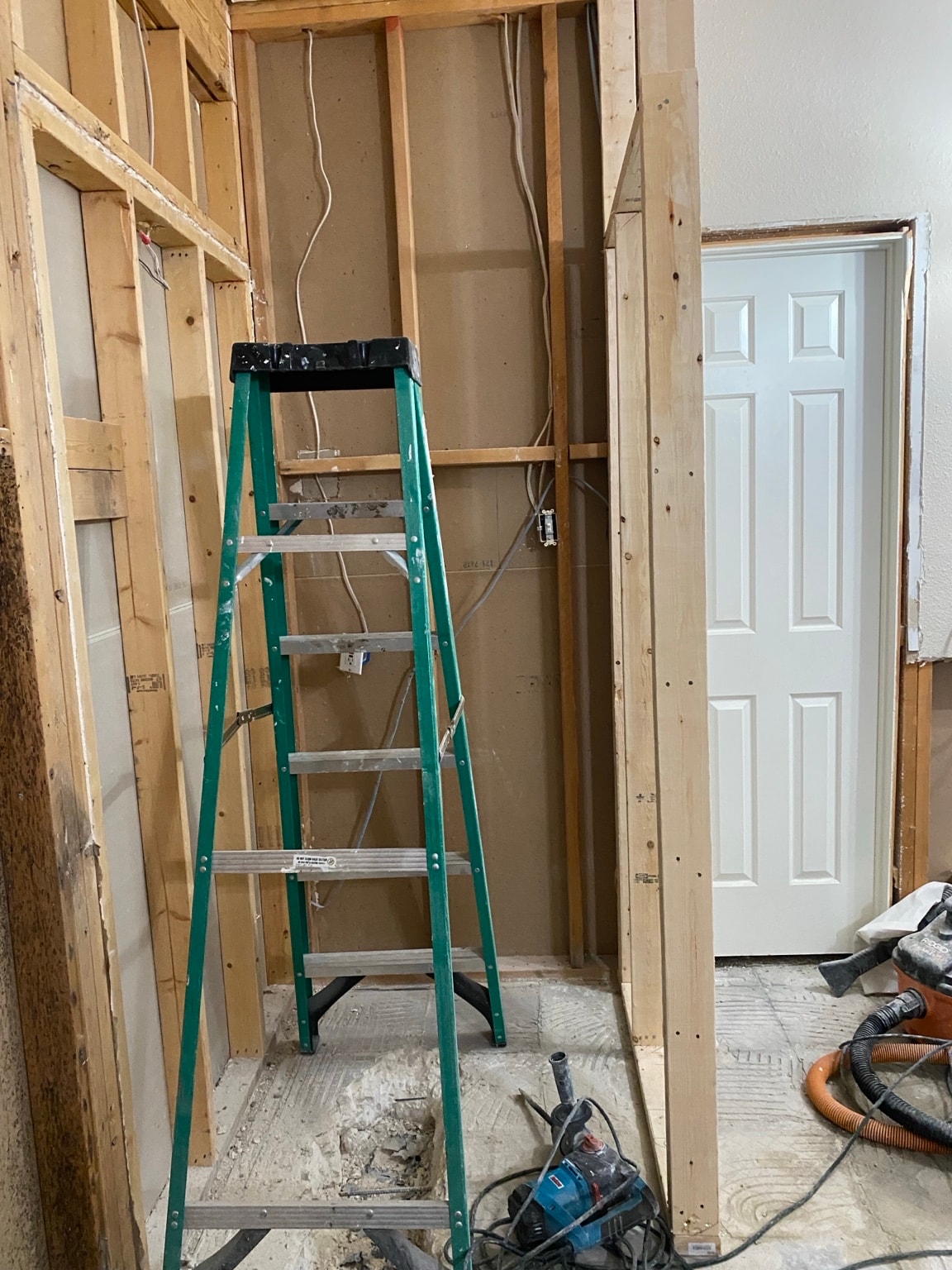 Shower tile installation in progress showing subway tile setting and decorative accent niche work